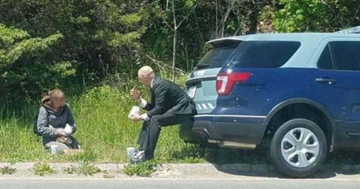 State Trooper Luke Bonin is seen sharing a meal he had purchased with a homeless women in Fall River, Massachusetts, in a photograph that went viral 5 years ago.