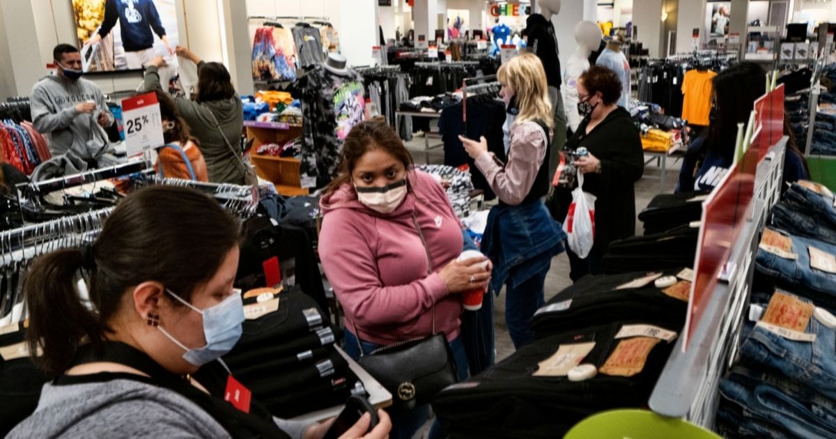 A group of Black Friday shoppers look through items at a J.C. Penney store at the Glendale Galleria Mall in Glendale, California on Nov. 26.