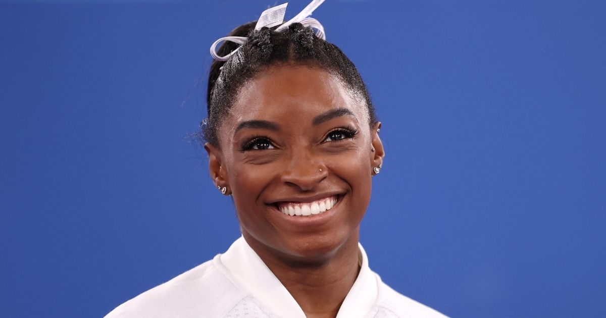 U.S. gymnast Simone Biles smiles during the women's team final of the Tokyo Olympic Games at the Ariake Gymnastics Centre in Tokyo on July 27.