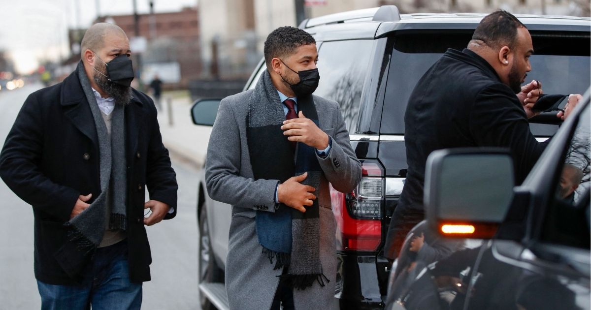 Actor Jussie Smollett, center, arrives at the courthouse in Chicago Monday for his trial on disorderly conduct charges for allegedly making false reports to authorities that he was the victim of a racist and homophobic attack in 2019.