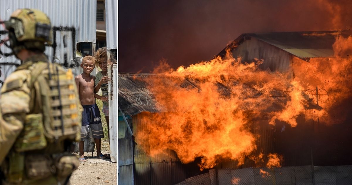 At left, young boys watch Australian Army Cpl. Aaron Woodham as he patrols Saturday. At right, a building burns in the capital city of Honiara, Solomon Islands, Friday, Nov. 26. Several nations are sending troops to help with violence that has erupted over the Pacific nation''s increasing links with China.
