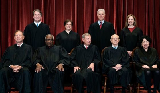 All nine acting Supreme Court justices line up to take photo on April 23. Seated from left are Associate Justice Samuel Alito, Associate Justice Clarence Thomas, Chief Justice John Roberts, Associate Justice Stephen Breyer and Associate Justice Sonia Sotomayor, and standing from left are Associate Justice Brett Kavanaugh, Associate Justice Elena Kagan, Associate Justice Neil Gorsuch and Associate Justice Amy Coney Barrett.