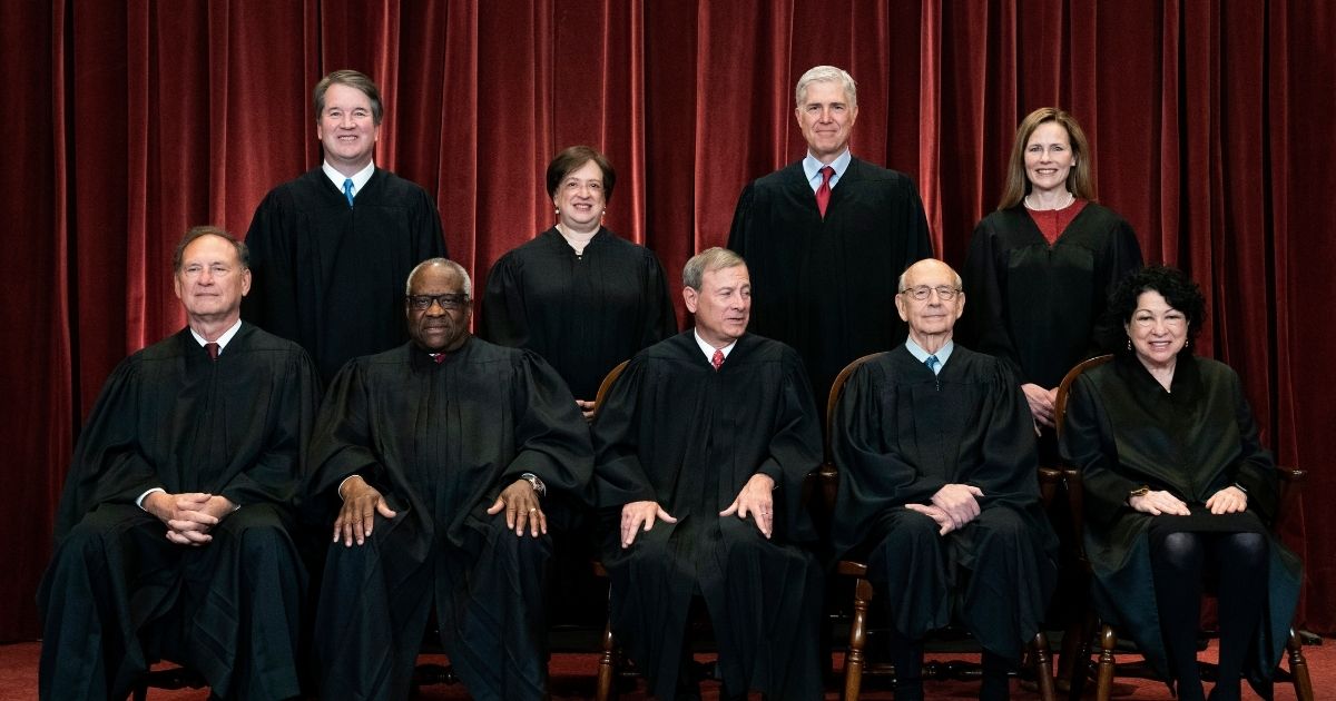 All nine acting Supreme Court justices line up to take photo on April 23. Seated from left are Associate Justice Samuel Alito, Associate Justice Clarence Thomas, Chief Justice John Roberts, Associate Justice Stephen Breyer and Associate Justice Sonia Sotomayor, and standing from left are Associate Justice Brett Kavanaugh, Associate Justice Elena Kagan, Associate Justice Neil Gorsuch and Associate Justice Amy Coney Barrett.