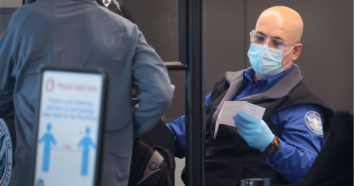 Transportation Security Administration workers screen passengers at O'Hare International Airport on Nov. 8 in Chicago.