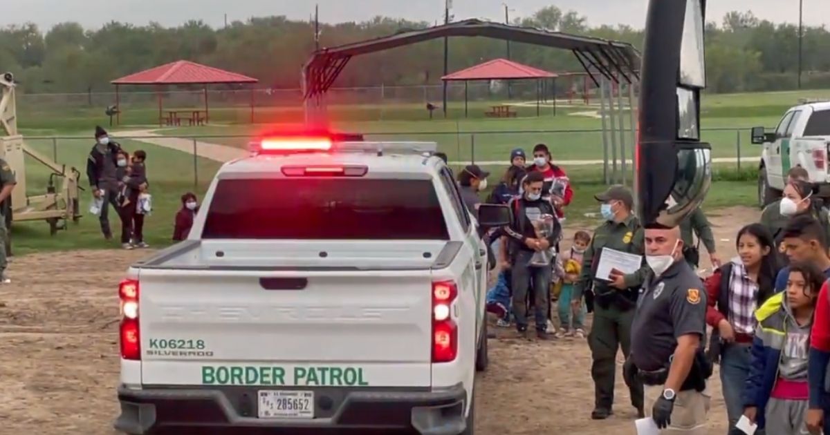 U.S. Border patrol agents stand by to put illegal immigrants crossing the border near La Joya, Texas, onto buses on Dec. 9.