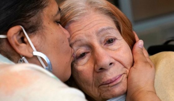 Rosa DeSoto, left, embraces her 93-year-old mother, Gloria, who suffers from dementia, inside the Hebrew Home at Riverdale in New York City in March 2021.
