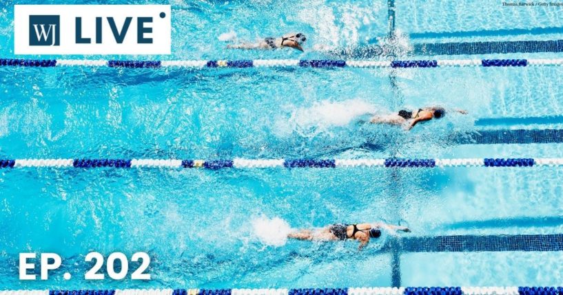 Swimmers compete in the above stock image.