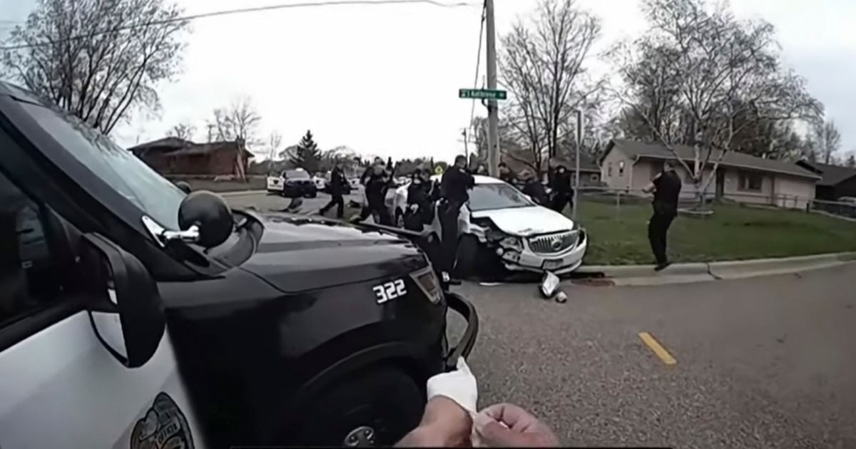 In this image taken from Brooklyn Center Police Officer Jeffrey Sommers' police body camera video that was played during the trial of former Brooklyn Center police Officer Kim Potter on Thursday in Minneapolis, police approach the car that Daunte Wright was driving after being shot during a traffic stop.