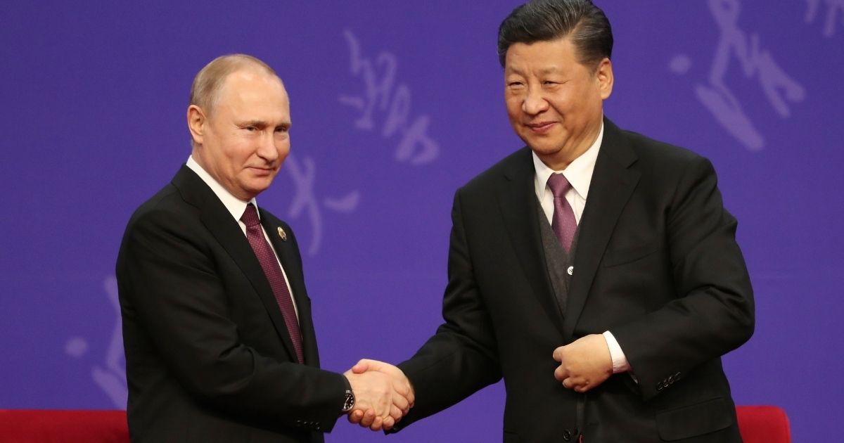 Russian President Vladimir Putin, left, shakes hands with Chinese President Xi Jinping on April 26, 2019, in Beijing.
