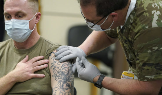 Staff Sgt. Travis Snyder receives his first dose of the Pfizer COVID-19 vaccine at Madigan Army Medical Center at Joint Base Lewis-McChord, south of Seattle, on Dec. 16, 2020.