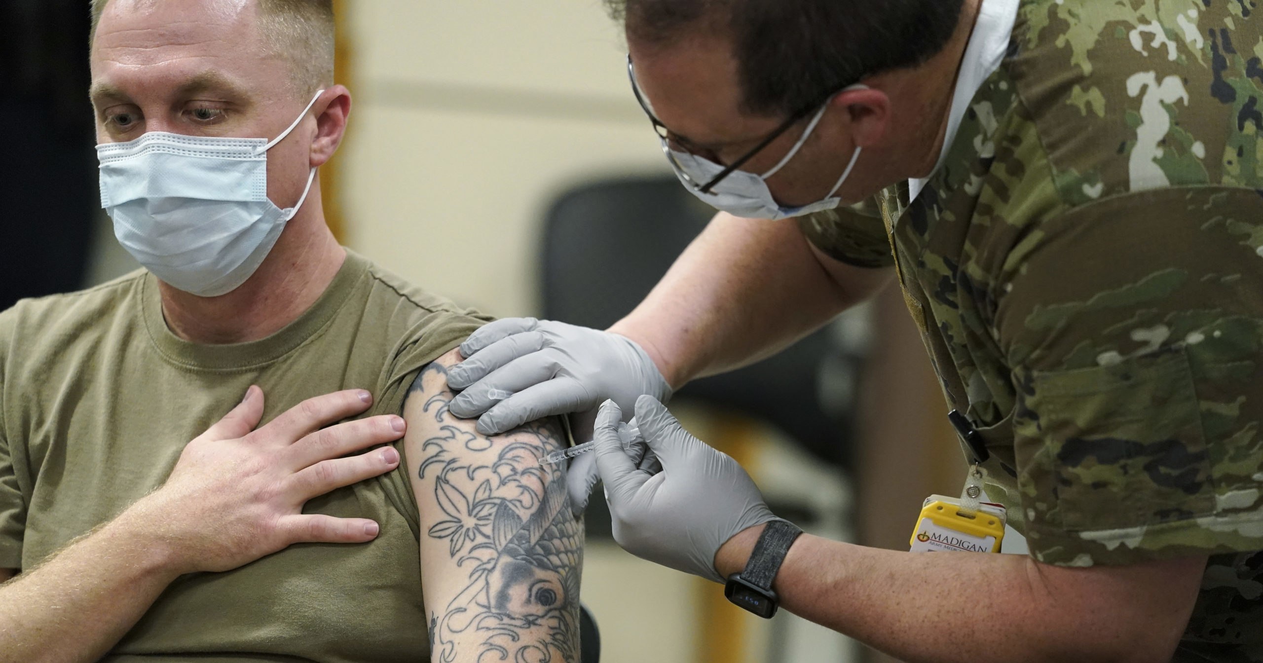 Staff Sgt. Travis Snyder receives his first dose of the Pfizer COVID-19 vaccine at Madigan Army Medical Center at Joint Base Lewis-McChord, south of Seattle, on Dec. 16, 2020.