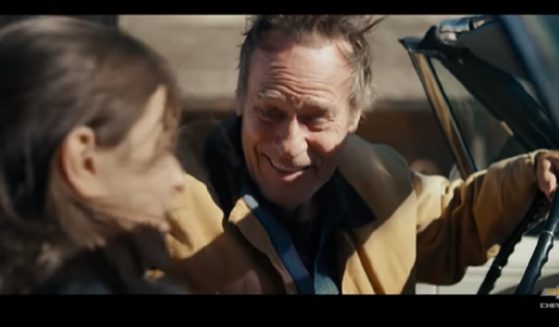 A scene from the Chevrolet ad shows a man in a restored Chevy Impala with his daughter.