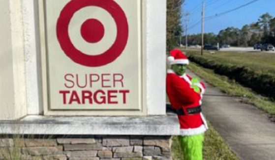A "Grinch" stands next to a Target Superstore sign in a Facebook post by the Flagler County, Florida, Sheriff's Office.