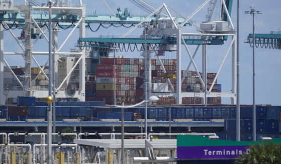 Cargo containers are seen stacked near cranes at Port Miami in Miami on April 9, 2021.