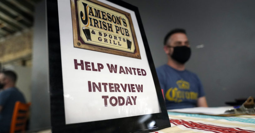 A hiring sign is shown at a booth for Jameson's Irish Pub during a job fair on Sept. 22, 2021, in the West Hollywood section of Los Angeles, California.