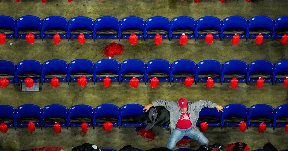 A Georgia fan waits for the start of the College Football Playoff championship football game against Alabama Monday, Jan. 10, in Indianapolis. 