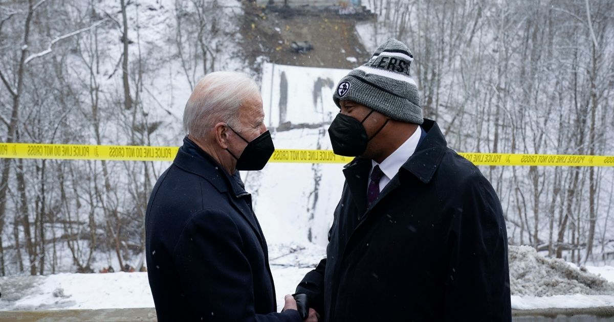 President Joe Biden shakes hands with Pittsburgh Mayor Ed Gainey as he visits the site where the Fern Hollow Bridge collapsed Friday in Pittsburgh's East End.