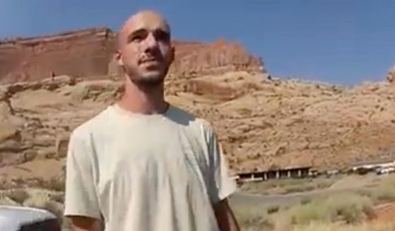 This Aug. 12, 2021, photo from video provided by the Moab Police Department shows Brian Laundrie talking to a police officer after police pulled over the van he was traveling in with his girlfriend, Gabby Petito, near the entrance to Arches National Park in Utah.