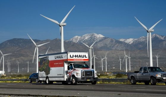 A U-Haul truck travels along Interstate 10 near Palm Springs, California, in this file photo from February 2019. U-Haul reported that the Golden State once again witnessed the largest net loss of one-way trucks. There were so many people renting trucks to flee California that the company said it ran out of inventory.