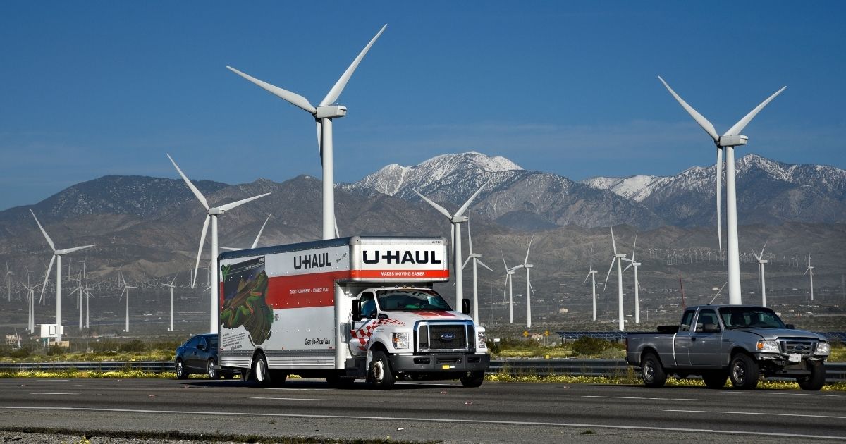 A U-Haul truck travels along Interstate 10 near Palm Springs, California, in this file photo from February 2019. U-Haul reported that the Golden State once again witnessed the largest net loss of one-way trucks. There were so many people renting trucks to flee California that the company said it ran out of inventory.