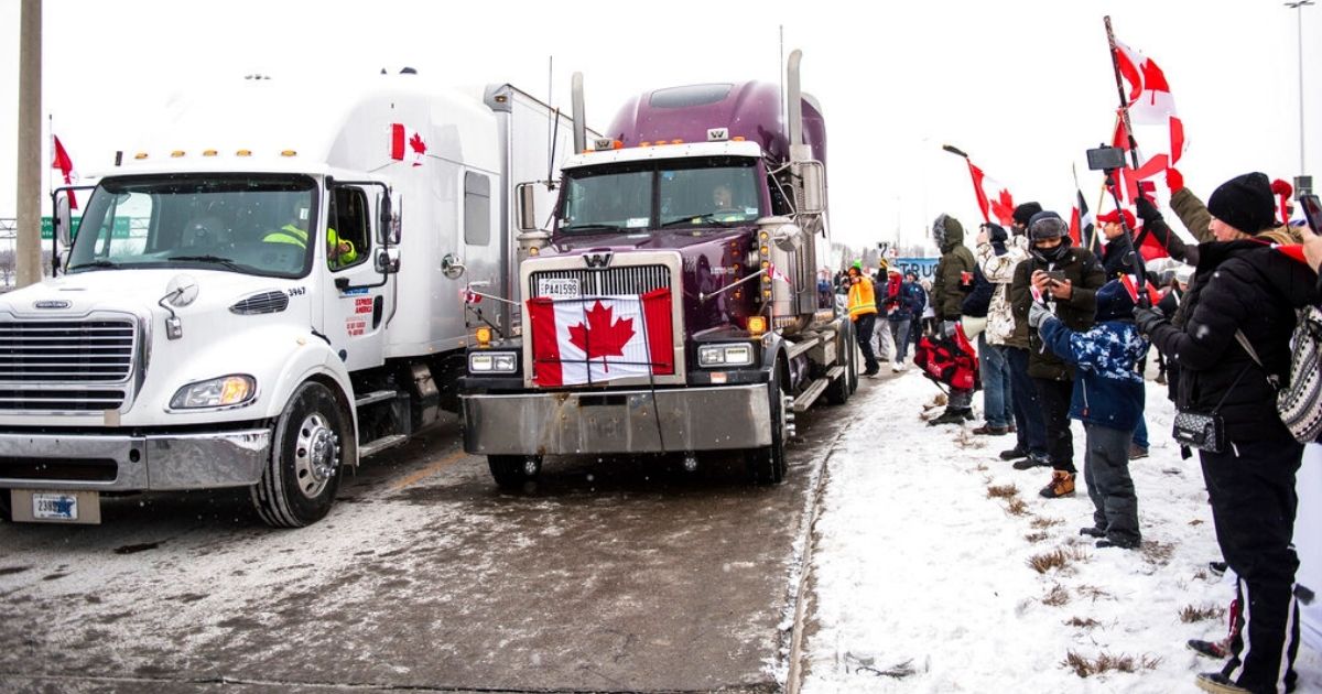 Protesters in Vaughan, Ontario, show their support for the Freedom Convoy of truck drivers who are making their way across Canada to protest against COVID-19 vaccine mandates by the Canadian government on Thursday. The convoy has reportedly reached a record length of 70 kilometers, or 43 miles long.