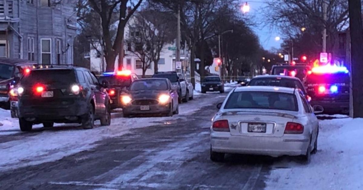 Six people were found murdered in a Milwaukee home on Jan. 23. Police cars were lined up outside the crime scene.
