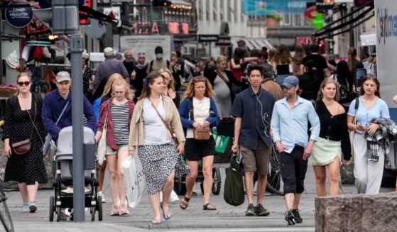 People walk along a busy shopping street in Copenhagen, Denmark, on June 10.