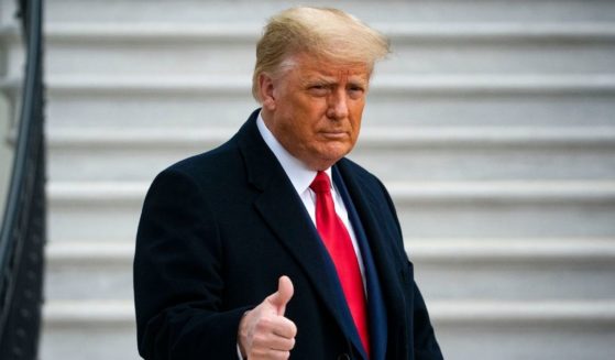 Then-President Donald Trump gives a thumbs up as he departs on the South Lawn of the White House on Dec. 12, 2020.