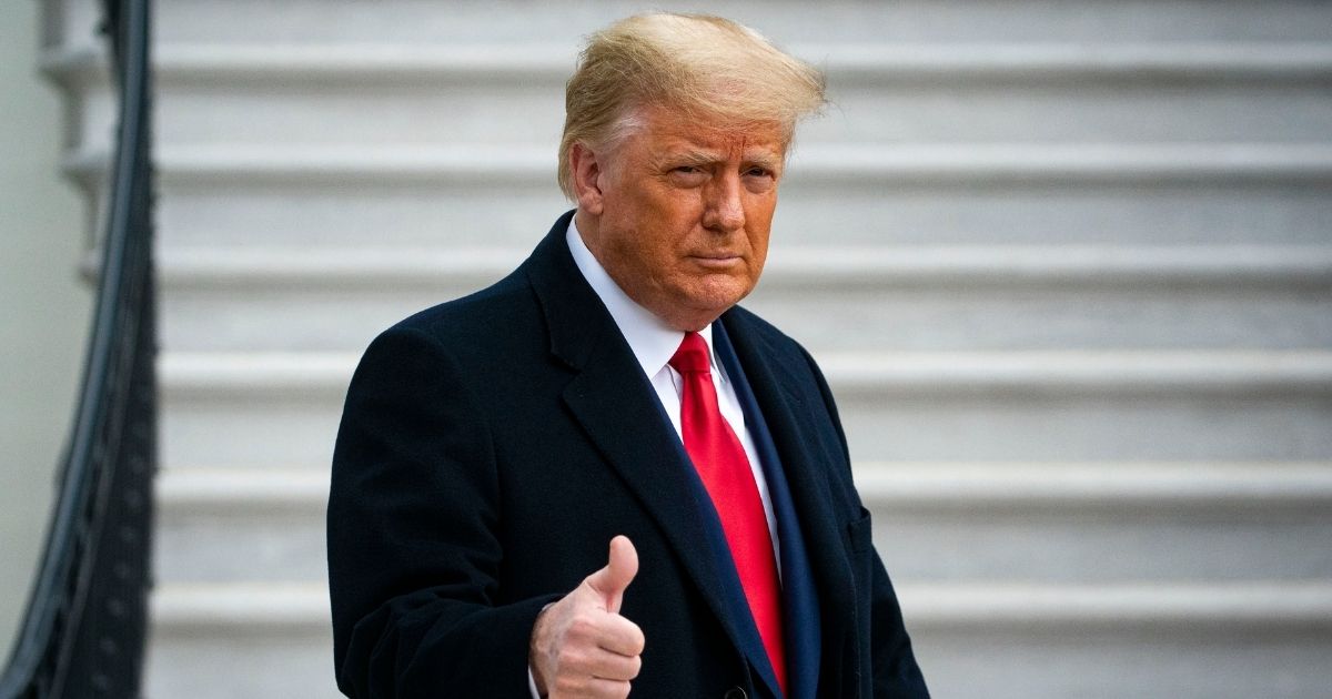 Then-President Donald Trump gives a thumbs up as he departs on the South Lawn of the White House on Dec. 12, 2020.