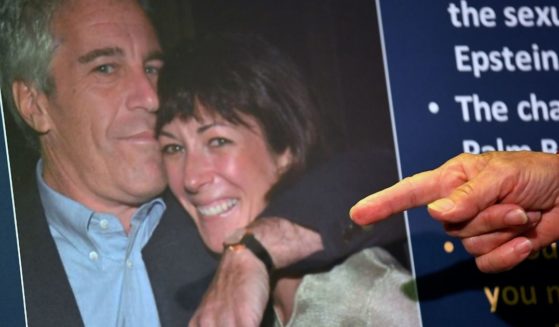 Federal prosecutors display a photo of Ghislaine Maxwell with her former boyfriend, Jeffrey Epstein, when announcing charges against the socialite during a July 2, 2020, news conference in New York City.
