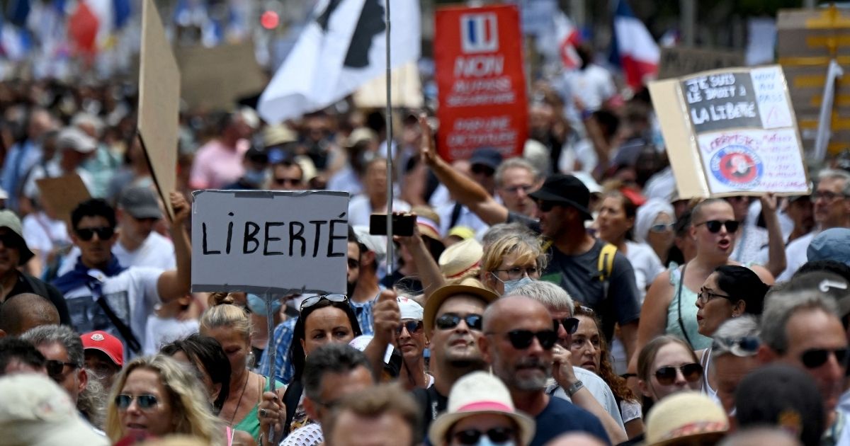 Crowds take part in a national day of protest against the government's mandatory COVID-19 health pass to access most public spaces in Toulon, France, on Aug. 7.