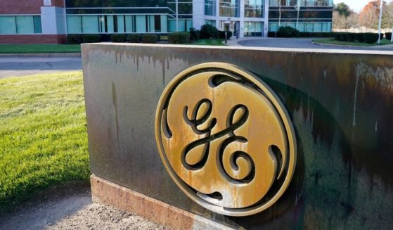 The General Electric logo is seen outside an office building in Foxborough, Massachusetts, on Nov. 9, 2021. The company has now done away with its vaccine mandate for its 56,000 employees.