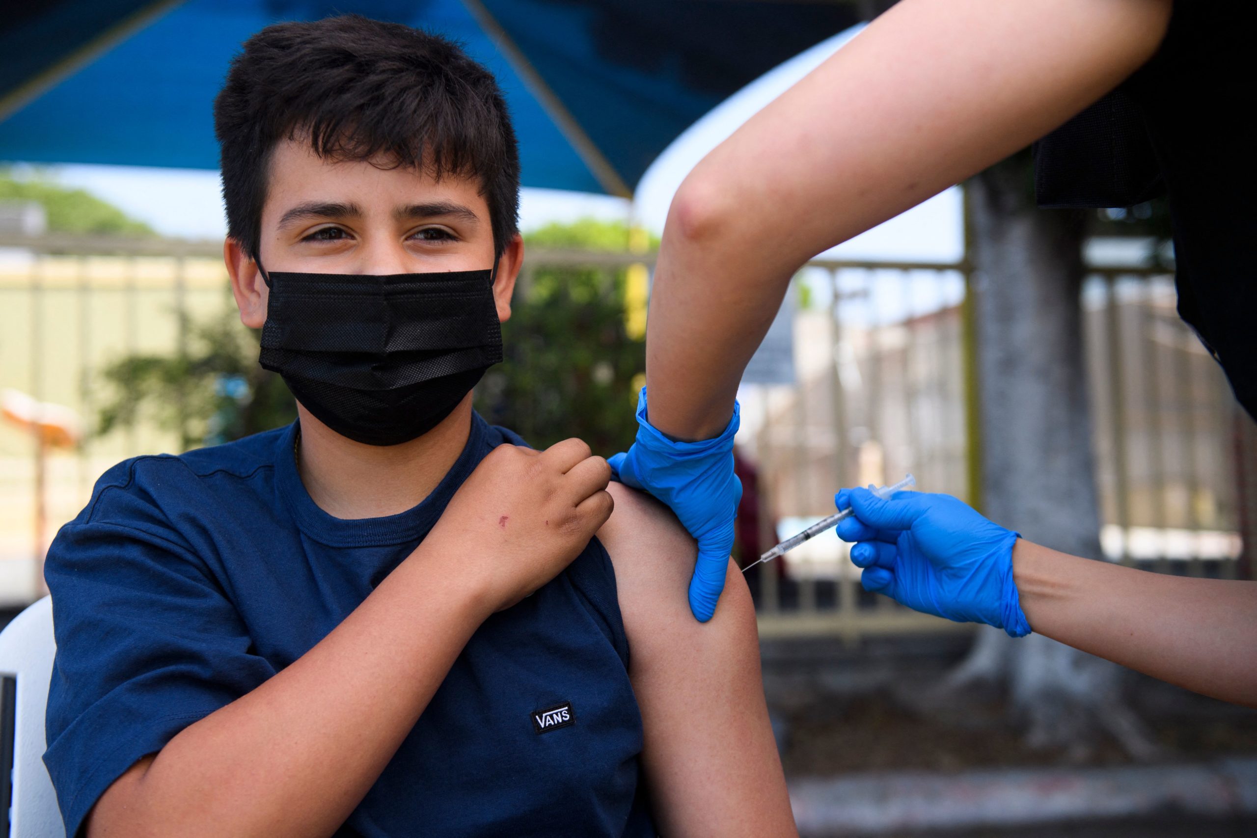 Simon Huizar, 13, receives a Pfizer COVID-19 vaccine at a mobile vaccination clinic at the Weingart East Los Angeles YMCA in this file photo from May 2021. Under a proposed new law, California children 12 and older could get vaccinated without parental permission.