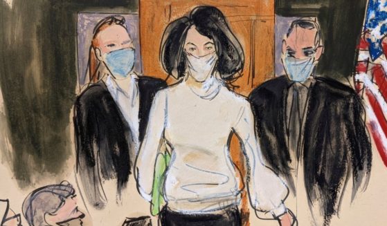 In this courtroom sketch, Ghislaine Maxwell enters the courtroom escorted by U.S. Marshalls at the start of her trial on Nov. 29, 2021, in New York.