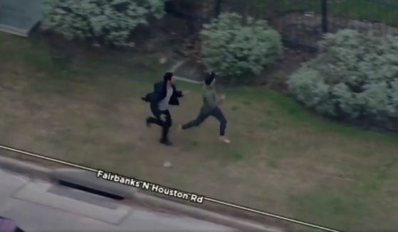 A former high school track athlete named Devin chases a suspected car thief on foot on Tuesday in Harris County, Texas.