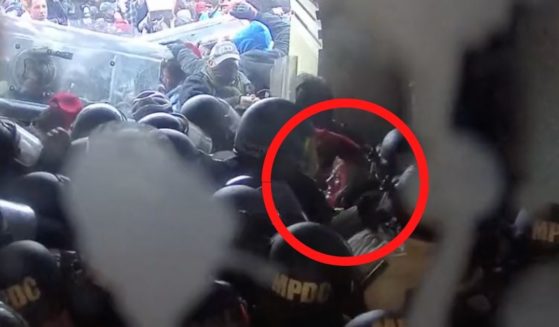 Victoria C. White, highlighted in the red circle, is seen on video being hit with a baton multiple times on the head and body while outside the Capitol in Washington, D.C., by D.C. Metropolitan Police on Jan. 6, 2021.