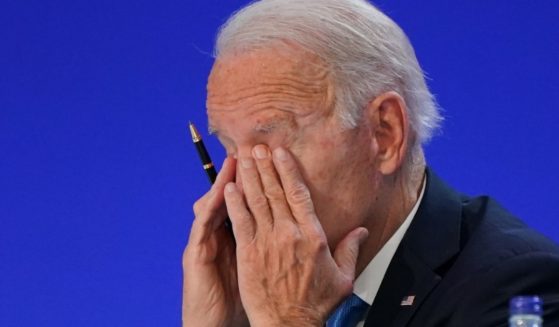 President Joe Biden puts his head in his hands during the U.N. Climate Change Conference in Glasgow, Scotland, on Nov. 2.