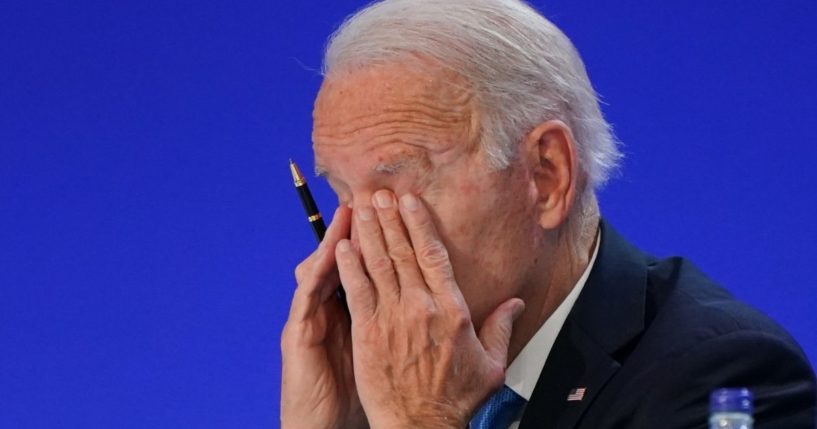 President Joe Biden puts his head in his hands during the U.N. Climate Change Conference in Glasgow, Scotland, on Nov. 2.