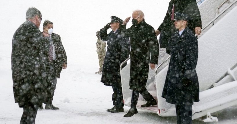 President Joe Biden arrives on Air Force One during a winter snowstorm at Andrews Air Force Base, Maryland, on Monday, en route to Washington.
