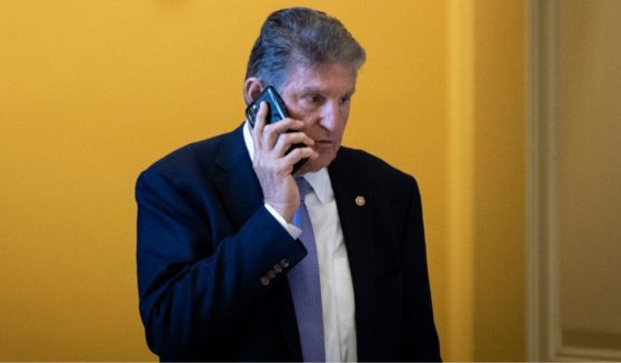 Democratic Sen. Joe Manchin of West Virginia talks on the phone at the U.S. Capitol in Washington on Nov. 16.