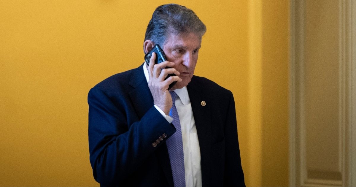 Democratic Sen. Joe Manchin of West Virginia talks on the phone at the U.S. Capitol in Washington on Nov. 16.