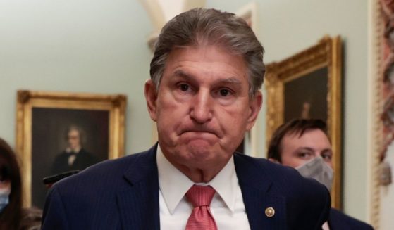 Sen. Joe Manchin of West Virginia is followed by reporters as he leaves a meeting with other Senate Democrats at the Capitol in Washington on Dec. 17.