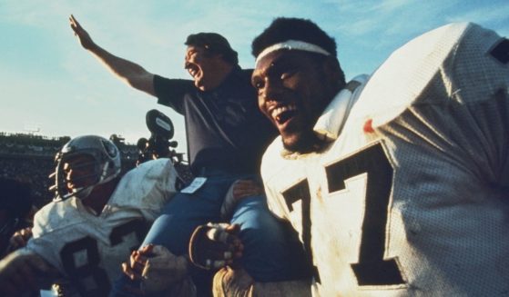 Oakland Raiders coach John Madden is carried off the field by linebacker Ted Hendricks, left, and defensive end Charles Philyaw after a 32-14 win over the Minnesota Vikings in Super Bowl XI at the Rose Bowl in Pasadena, California, on Jan. 9, 1977.