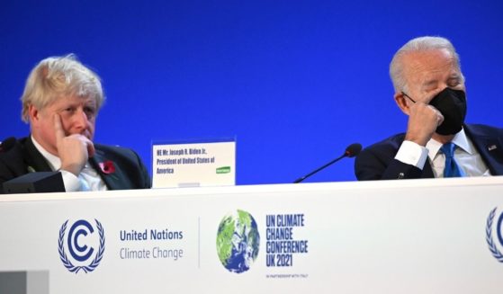 British Prime Minister Boris Johnson, left, and President Joe Biden, right, sit down during the "Accelerating Clean Technology Innovation and Deployment" summit, which was a part of the COP26 Summit in Glasgow, Scotland, on Nov. 2, 2021.