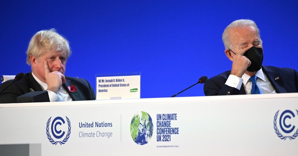 British Prime Minister Boris Johnson, left, and President Joe Biden, right, sit down during the "Accelerating Clean Technology Innovation and Deployment" summit, which was a part of the COP26 Summit in Glasgow, Scotland, on Nov. 2, 2021.