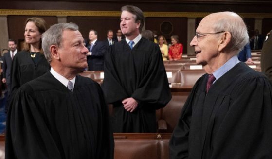 Supreme Court Chief Justice John Roberts, left, speaks with retiring Associate Justice Stephen Breyer as they attend President Joe Biden's State of the Union address at the Capitol in Washington on March 1.