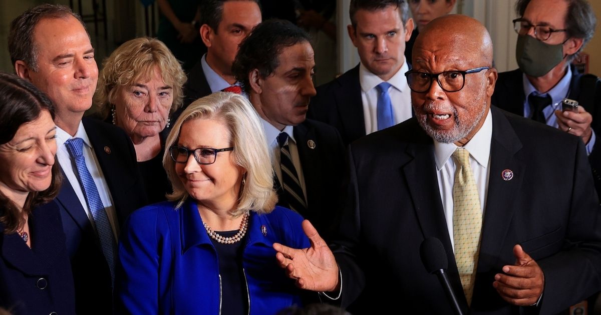 Rep. Liz Cheney of Wyoming stands with Jan. 6 House Committee Chairman Rep. Bennie Thompson, a Mississippi Democrat, and fellow committee members as they speak to the media following a hearing in July. The January 6 committee served subpoenas Tuesday on several former associates of President Donald Trump who are now working on the campaign of Cheney's political challenger.