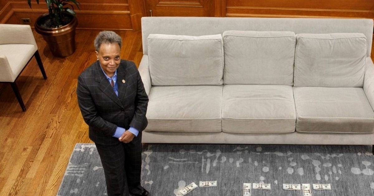 Chicago Mayor Lori Lightfoot has been roasted mercilessly on Twitter after posing with a rather bizarre 'Get Vax'd' message spelled out in US currency to promote a lottery that encourages citizens to receive at-home COVID shots.