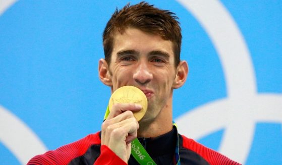 U.S. swimmer Michael Phelps celebrates his Olympic gold medal on the podium during the medal ceremony for the men's 200m Individual medley at the Olympic Aquatics Stadium in Rio de Janeiro on Aug. 11, 2016.