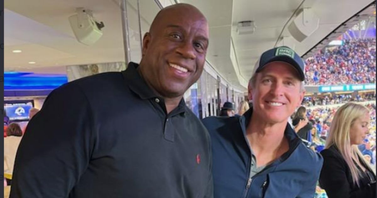 Basketball star Magic Johnson, left, and California Gov. Gavin Newsom, right, pose for a picture during the NFL's NFC championship game at SoFi Stadium in Inglewood, California on Sunday. This photo has received harsh criticism as neither man is wearing a mask, which is part of California's strict COVID-19 policies.